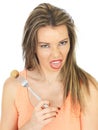 Young Woman Holding a Pickled Onion on a Fork