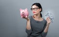 Woman holding a piggy bank with us dollar bills Royalty Free Stock Photo