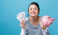 Young woman with a piggy bank with us dollar bills Royalty Free Stock Photo