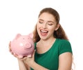 Young woman holding piggy bank on white background. Money savings concept Royalty Free Stock Photo