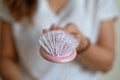 The young woman is holding pink hairbrush that is full of hair loss. Royalty Free Stock Photo