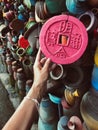 Young woman holding pink pottery souvenir at market in Bali