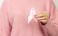 Young woman holding pink ribbon breast cancer awareness. World cancer day concept Royalty Free Stock Photo
