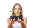 Young woman holding plant, celery sprout