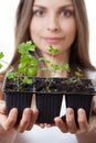 Young woman holding plant, celery sprout