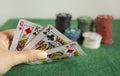 Young woman holding poker cards