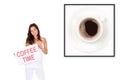 Young woman holding a poster in front of a photo of a cup of coffee Royalty Free Stock Photo