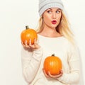 Young woman holding pumpkins