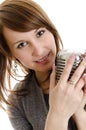 Young woman holding a retro-microphone. Royalty Free Stock Photo