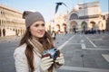 Young woman holding retro photo camera on Piazza San Marco Royalty Free Stock Photo