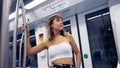 Young woman holding with right hand inside Barcelona tube