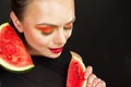 A young woman is holding a ripe sliced watermelon in her hands. Royalty Free Stock Photo