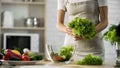 Young woman holding salad leaves in hand, organic lunch ingredients, hobby