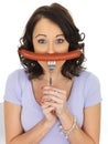 Young Woman Holding a Saveloy Sausage Royalty Free Stock Photo