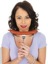 Young Woman Holding a Saveloy Sausage Royalty Free Stock Photo