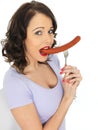 Young Woman Holding a Saveloy Sausage Royalty Free Stock Photo