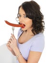 Young Woman Holding a Saveloy Sausage Royalty Free Stock Photo