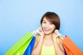 young woman holding shopping bags before blue background Royalty Free Stock Photo