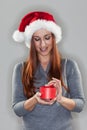 Young woman holding a small Christmas gift Royalty Free Stock Photo