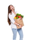 Young woman holding shopping bag full of vegetables isolated on white background. Royalty Free Stock Photo