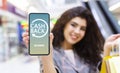 Young Woman Holding Smartphone With Opened Cashback Application On Screen