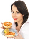 Young Woman Holding Smoked Salmon and Cream Cheese Bagel Royalty Free Stock Photo