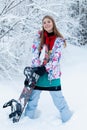 Young woman holding snowboard on her shoulders Royalty Free Stock Photo