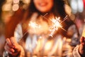 Young woman holding sparklers