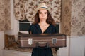 Young woman holding suitcase in her hands. Royalty Free Stock Photo