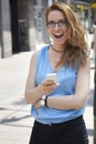 Young woman holding a tablet on the street