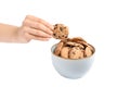 Young woman holding tasty chocolate chip cookie over bowl on white background Royalty Free Stock Photo