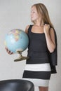 Young woman holding a terrestrial globe Royalty Free Stock Photo