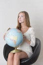 Young woman holding a terrestrial globe Royalty Free Stock Photo