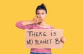 Young woman holding there is no planet b banner covering mouth with hand, shocked and afraid for mistake Royalty Free Stock Photo