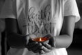 Young woman holding candle light in hands. Be the light concept. On black and white background Royalty Free Stock Photo