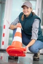 young woman holding traffic cone Royalty Free Stock Photo