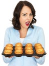 Young Woman Holding a Tray of Yorkshire Puddings Royalty Free Stock Photo