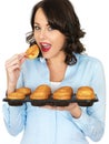 Young Woman Holding a Tray of Yorkshire Puddings Royalty Free Stock Photo