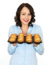 Young Woman Holding a Tray of Yorkshire Puddings Royalty Free Stock Photo