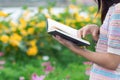 Young woman holding up a Bible to read because she wants to learn the teachings of God from the Bible with faith and faith in God