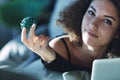 Young woman holding up a blue Xmas decoration Royalty Free Stock Photo