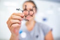 Young woman holding up a molecular model