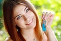 Young woman holding up a set of keys Royalty Free Stock Photo