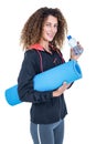 Young woman holding water bottle and exercise mat Royalty Free Stock Photo