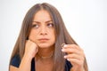 A girl holding a wedding ring doubtfully