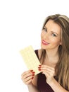 Young Woman Holding a White Chocolate Bar Royalty Free Stock Photo