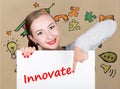 Young woman holding whiteboard with writing word: innovate. Technology, internet, business and marketing. Royalty Free Stock Photo