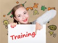 Young woman holding whiteboard with writing word: training. Technology, internet, business and marketing.