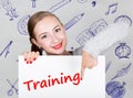 Young woman holding whiteboard with writing word: training. Technology, internet, business and marketing.