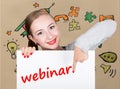 Young woman holding whiteboard with writing word: webinar. Technology, internet, business and marketing.